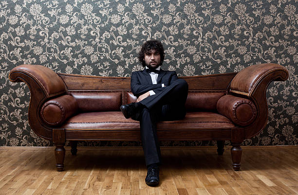 istock Lonely man sitting on sofa right after party 182033330