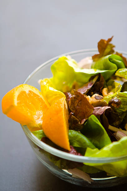 istock Mixed Salad with Orange Slices Isolated on Black 182033377