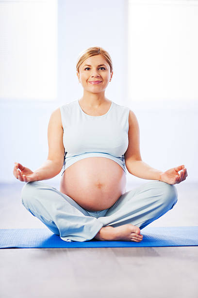 istock Young pregnant woman meditating. 182033461