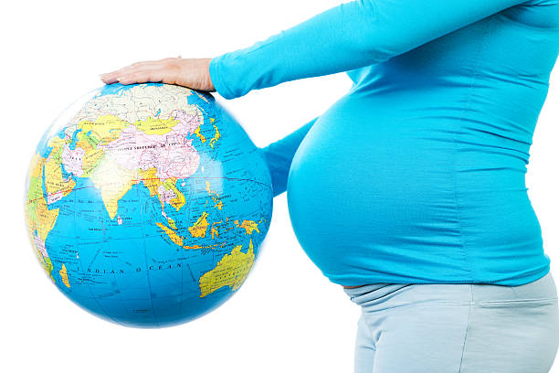 istock Pregnant  woman holding a globe. 182033496