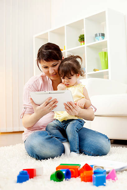 istock Mother and child having fun with digital tablet. 182033563