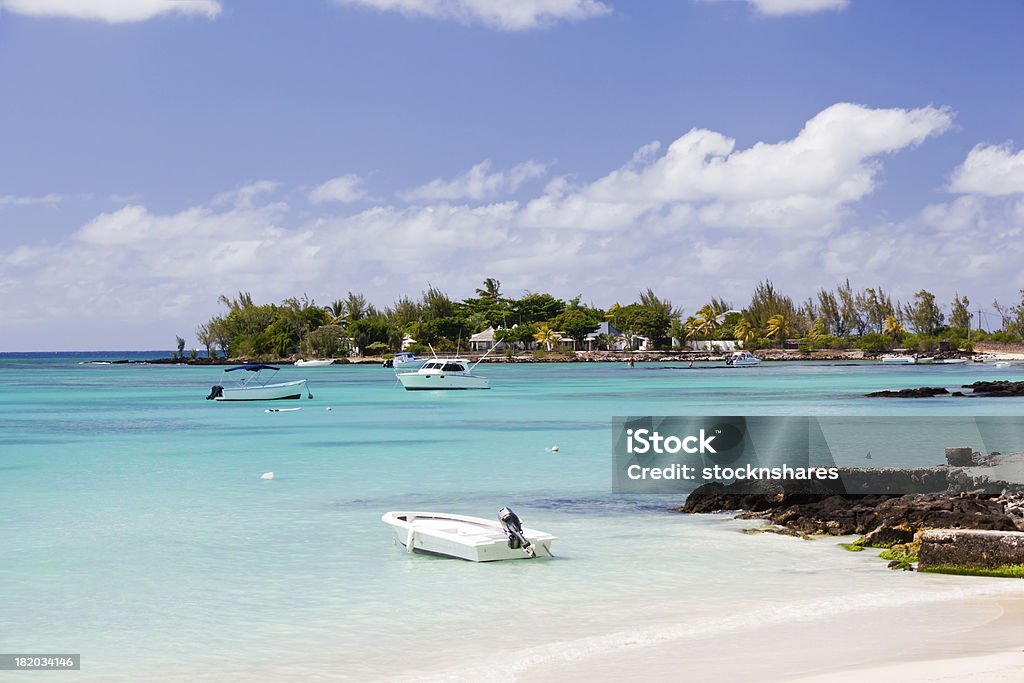 Pereybere Beach Mauritius "The idyllic bay and beach at Pereybere, near Grand Baie, in the north of the tropical island of Mauritius. An ideal sheltered beach, with turquoise shallow lagoon waters. Great for swimming, fishing, sunbathing, or playing around in boats." Mauritius Stock Photo