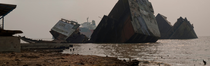 Ship breaking yards of Bangladesh through the foggy and toxic atmosphere.Along the southeast coast of Bangladesh is the Chittagong - Sitakunda ship breaking yard where immense ocean freighters and tankers are torn apart.