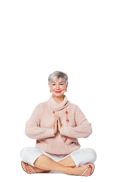 istock Senior Woman Doing Yoga On the Floor 182035736