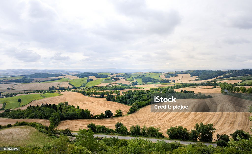 patchwork landscape at moody sky in France "view on a field stubble patchwork landscape at a moody sky in Fanjeaux, Pyrenees-Orientales, Languedoc-Roussillon, France" France Stock Photo