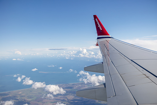 England - October 24th 2023: Winglet of a Boeing 737 Max 8 from the Norwegian airline crossing the English coastline enroute to Gatwick