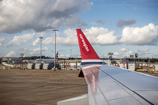 Gatwick, England - October 24th 2023: Wing of a Boeing 737 Max 8 from the Norwegian airline  while taxing at Gatwick Airport