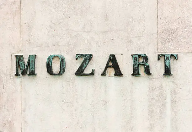 Close-up of the surname of the iconic 18th Century classical composer, Wolfgang Amadeus Mozart (1756 – 1791), at the base of the statue dedicated to the composer in his city of birth, Salzburg in Austria.