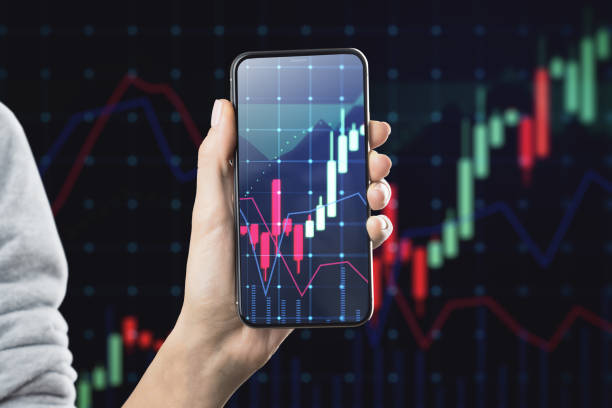 istock Hand holding smartphone with stock market data on screen 1820365123