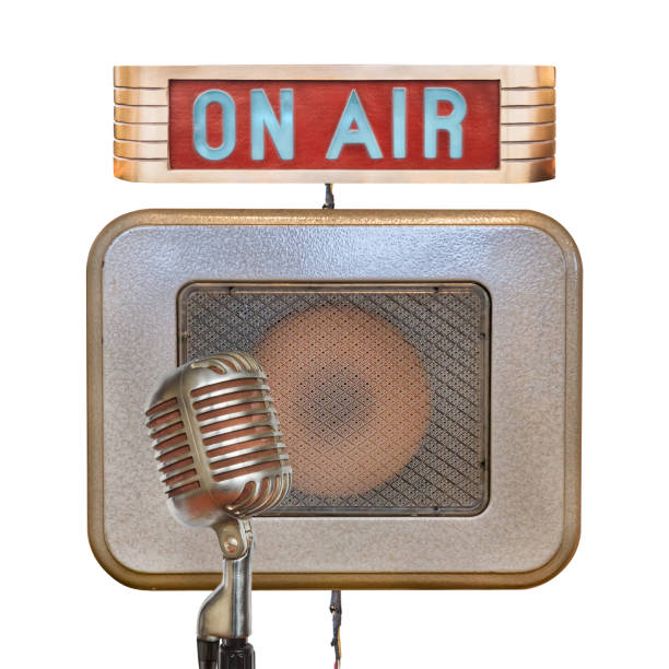 Vintage microphone with on air illuminated sign and speaker on a white background