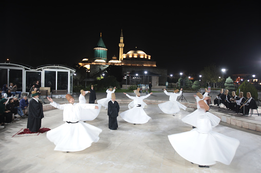 Konya, Turkey - October 19, 2023: Dervishes are doing meditation dancing for the God. The dance Whirling Dervishes is called Sema in Konya - Turkey.