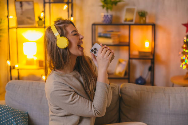 istock Beautiful woman listening to music while singing and dancing 1820388043