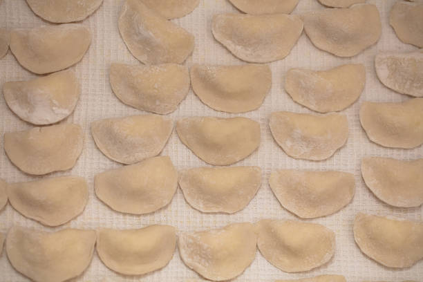 High Angle View Of Uncooked Curry Puffs On Tray