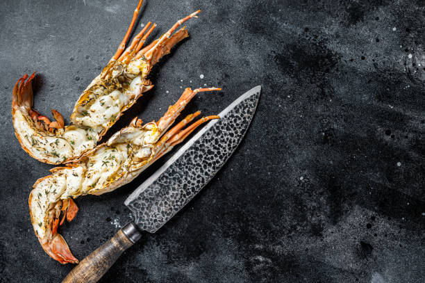 istock BBQ Grilled Spiny lobster sliced on a cutting board Black background. Top view. Copy space 1820397147