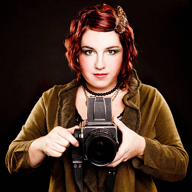 istock Woman Winding a Vintage Camera 182041173