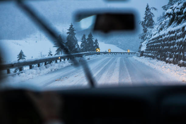 Driving on Hazardous Snow-Covered Roads Proficient Driver's View, Navigating Through Hazardous Snow-Covered Roads, Weather Shifts, and Unplowed Routes in the Countryside windshield wiper snow stock pictures, royalty-free photos & images