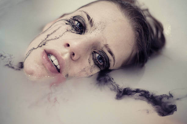 Dissolution. The rivers of tears close-up portrait of the beautiful young woman with the smeared and begun to flow make-up in water flushing water stock pictures, royalty-free photos & images