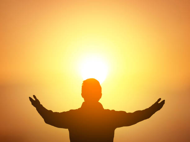 istock Human hands open palm up worship on sunset sky background. 1820425363