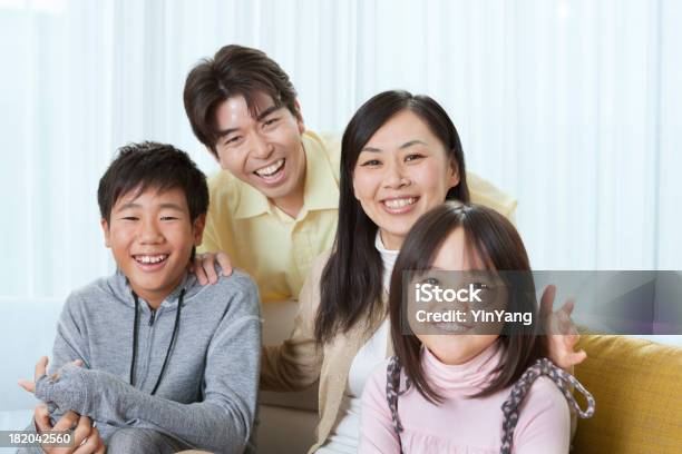 Portrait Of Young Japanese Family In Their Home Interior Stock Photo - Download Image Now