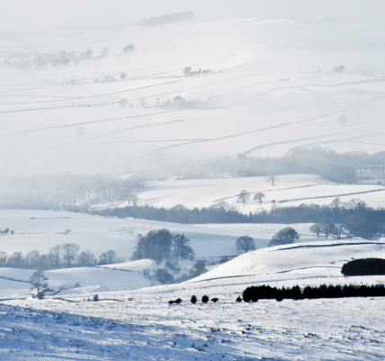 Snowy fields shrouded in mist. Eden Valley in Cumbria. Taken from Hartside Summit on the A686 Penrith to Alston pass. December 2010.