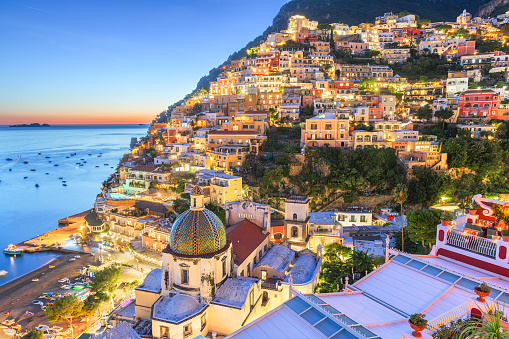 Positano, Italy along the Amalfi Coast at dusk.