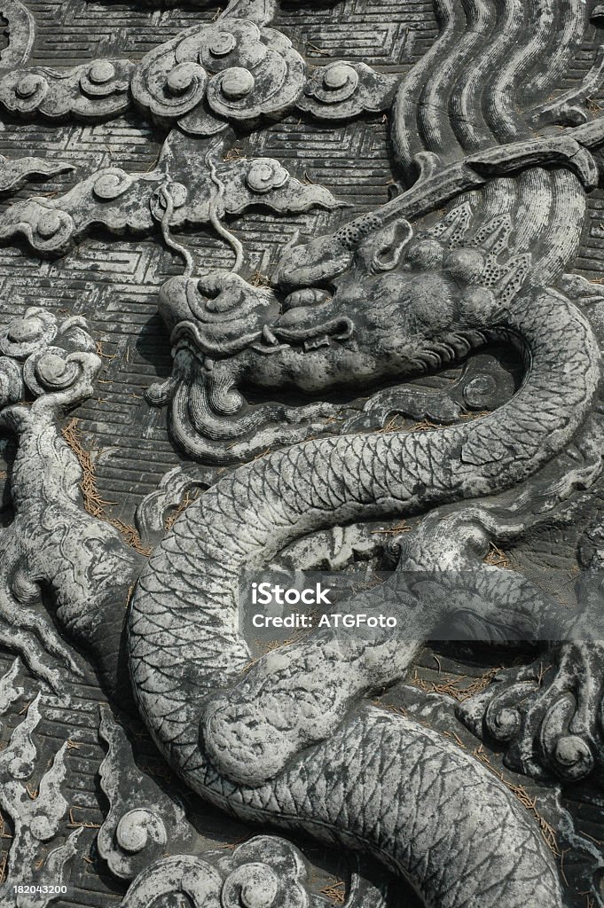 Tomb Stone With Chinese Dragon Symbol of a Chinese dragon on the stone cover of a Ming tomb. The Ming Tombs, Beijing, China. Architectural Feature Stock Photo