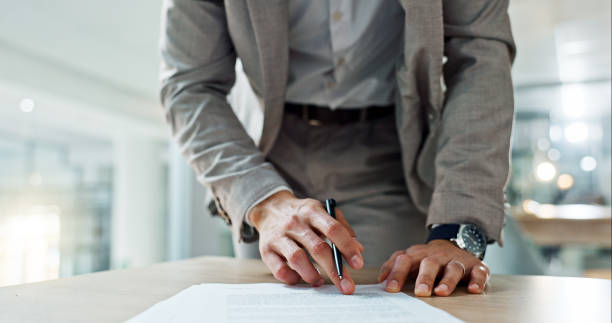 istock Business, hands and writing signature on contract or legal documents for application or agreement in office. Pen, closeup and person reading paperwork, work policy or form in workplace or company 1820432510