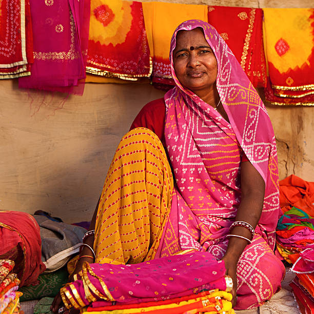 istock Woman selling colorful fabrics 182043596