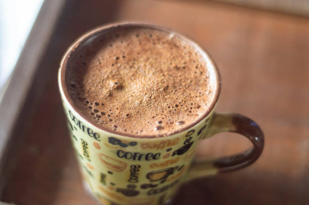 istock Large cup of coffee with cappuccino on a wooden table, image top view 1820436387