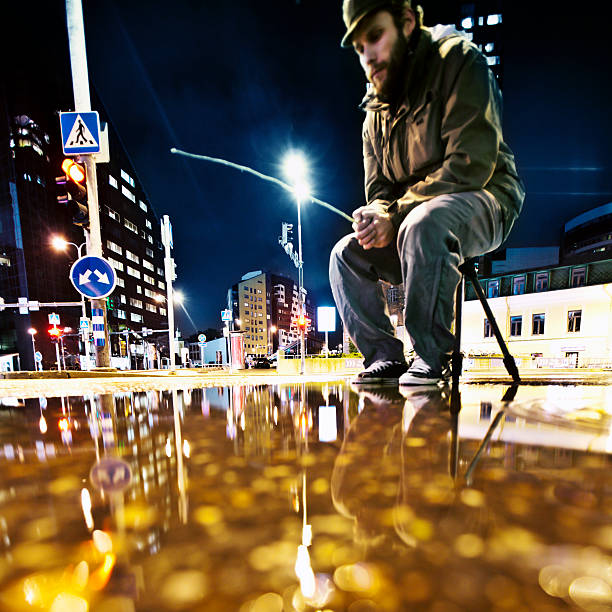 fisherman fishing from the puddle in downtown.