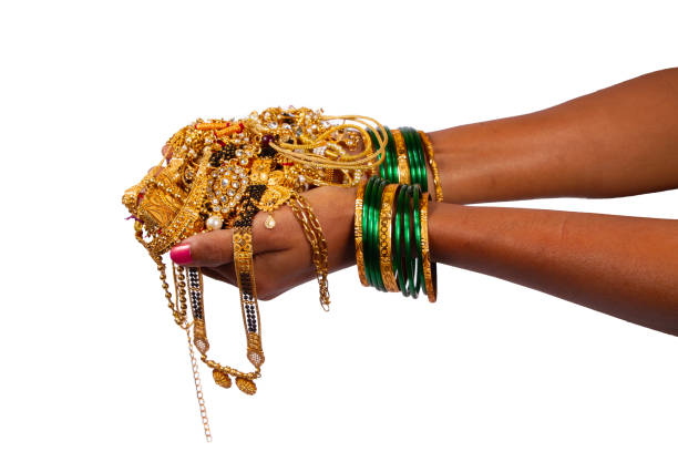 istock gold jewelery in hand isolated on white background. 1820442943