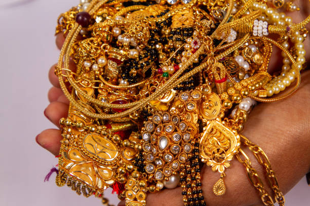 istock gold jewelery in hand isolated on white background. 1820442962