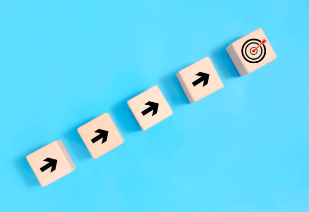 istock Setting goals to plan for the future Group of businessmen holding target board with flags on mountain A clear concept of planning process and teamwork. 1820447321