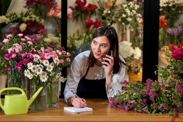 istock nice attractive flower shop owner talking on phone with client. Small business. 1820449970