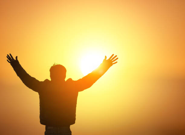 istock Human hands open palm up worship on sunset sky background. 1820455518