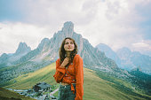 Portrait of cheerful woman enjoying Paso Giau in Dolomites