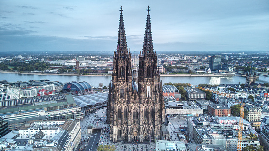 The medieval gothic Cologne Cathedral in the city of Cologne in Germany with the Rhine River in the background.