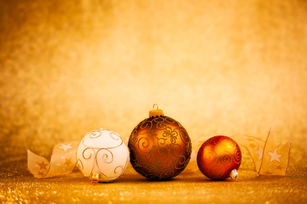 Golden Christmas Baubles on glitter background