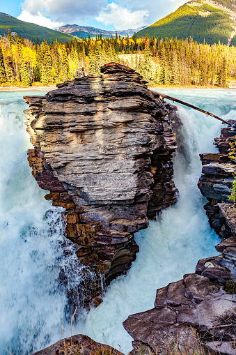 Magnificent rock divides thundering Athabasca Falls. Athabasca Falls is the most powerful waterfall in Alberta. Jasper Park. Canadian Rockies.