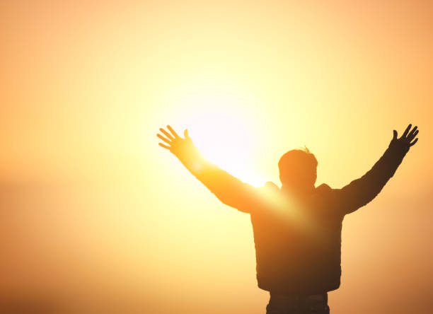 istock Human hands open palm up worship on sunset sky background. 1820488251