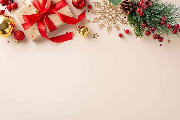 istock Preparing for New Year bash! Top view craft paper present box, red and gold balls, pine cone, mistletoe, frosted fir, confetti decorate pastel beige backdrop, leaving space for your joyful message 1820492070