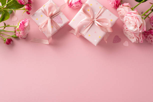 istock Love Tokens: Top view composition featuring gift boxes, pink roses, and heart confetti. Pastel pink backdrop with ample space for text 1820492079