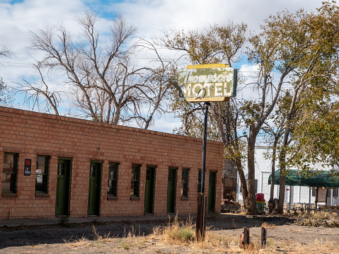 Thompson, Utah, USA-November 8, 2023:Abandon motel with weed filled lot and old sign, Thompson, Utah.