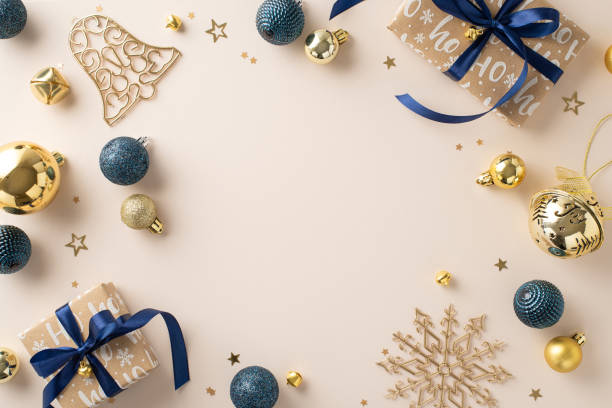 istock Infuse your New Year visuals with warmth. Top view craft paper gift boxes, luxurious baubles, jingle bell, confetti scatter across pastel beige scene, offering empty space for text or promo content 1820492150