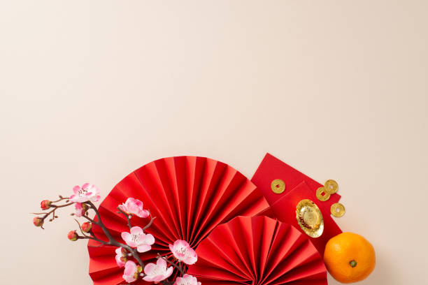 istock Elevate your Chinese New Year celebration with this visually pleasing arrangement. Top view of fans, Feng Shui essentials, tangerine, and more on neutral background, space for your celebratory message 1820492612