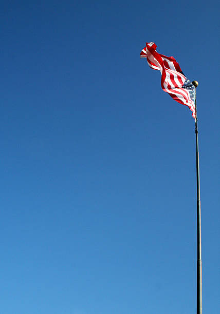 Flying High U.S. Flag on edge on the edge of a dark blue sky.To see my full collection of USA flag photos click on the photos below: national day of prayer stock pictures, royalty-free photos & images