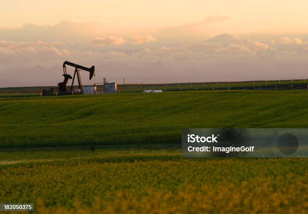 Oil Rig On A Grass Field With A Cloudy Sky Stock Photo - Download Image Now - East, Texas, Alberta