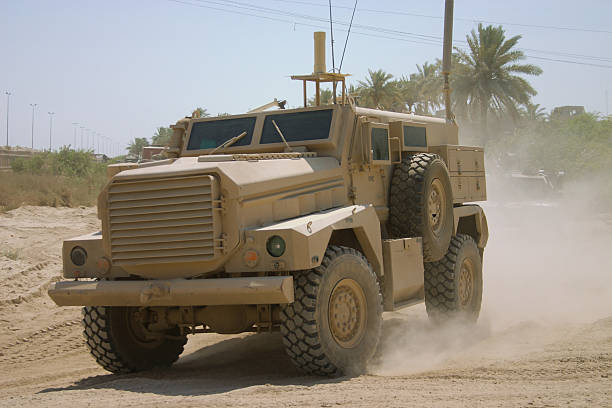 IED Truck A Specialized anti-IED U.S. truck goes on patrol. armoured truck stock pictures, royalty-free photos & images