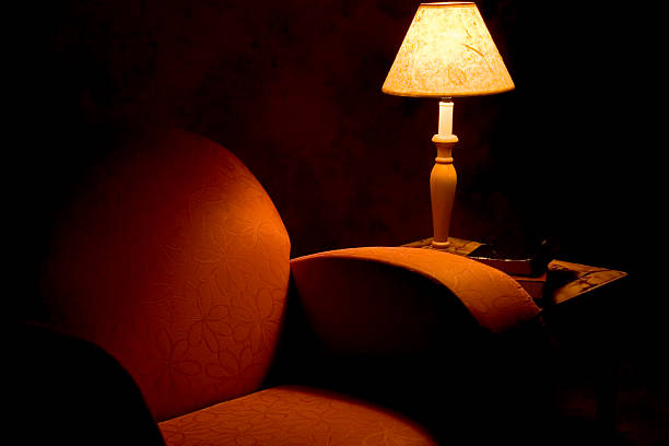 istock Big armchair and lamp in dimmed lighting 182050903