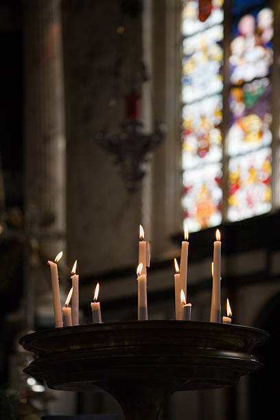 istock Church candles with stained glass in background 182051453